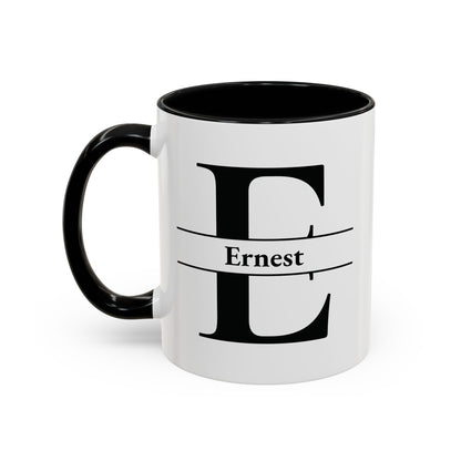 A white ceramic 11oz mug with a black handle and black interior, featuring a large black letter 'E' and the name 'Ernest' printed on the front. Left handle view.