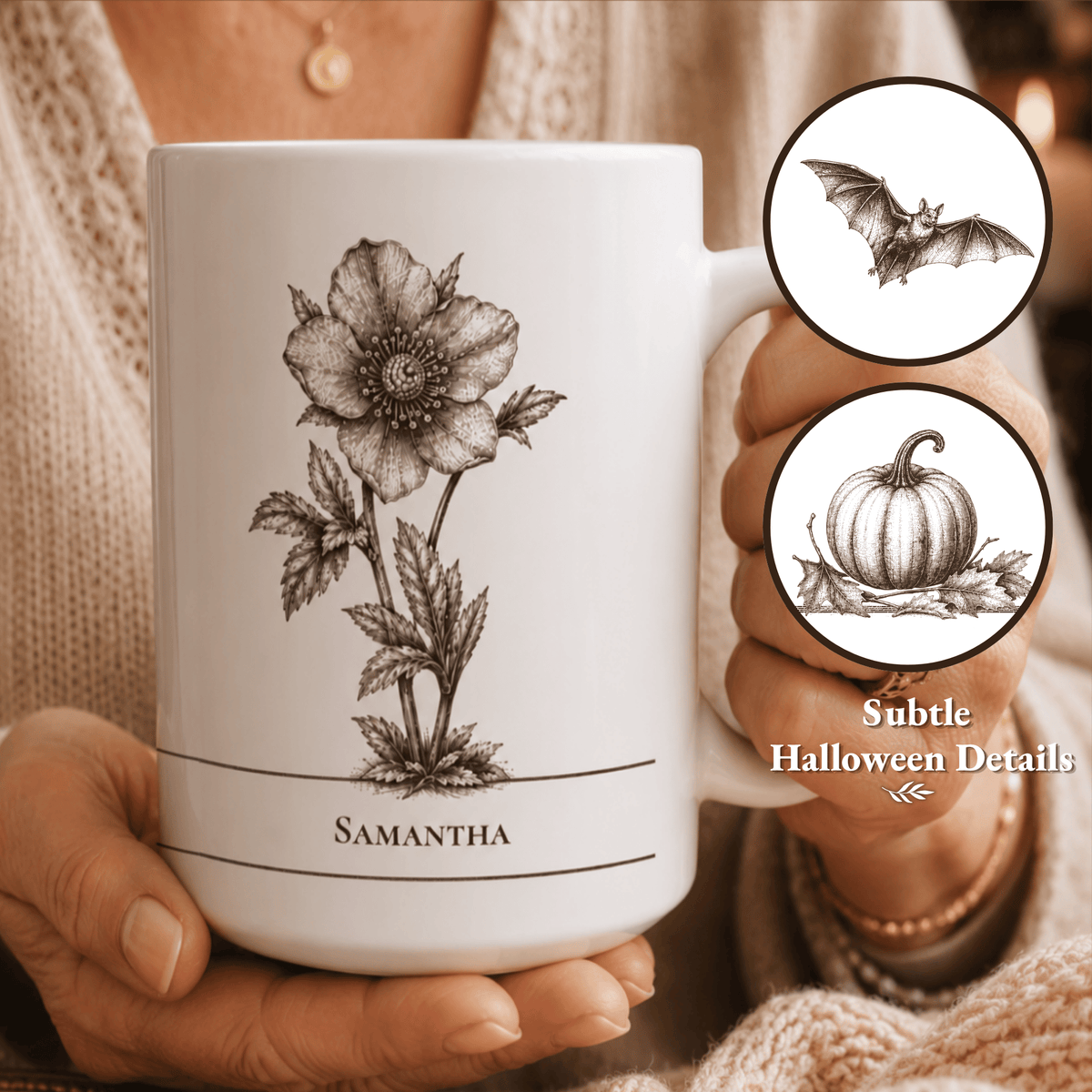 A white ceramic mug with a black botanical illustration of a hellebore flower and a name 'Samantha' printed near the bottom, held by a person wearing a cream knit sweater. Two circular inset callouts on the right show subtle Halloween-themed details: a bat and a pumpkin.