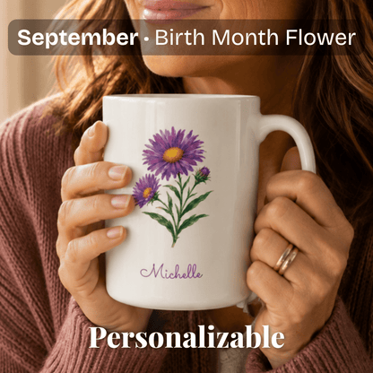 A woman holds a white ceramic mug with aster birth flower and personalized name at bottom.