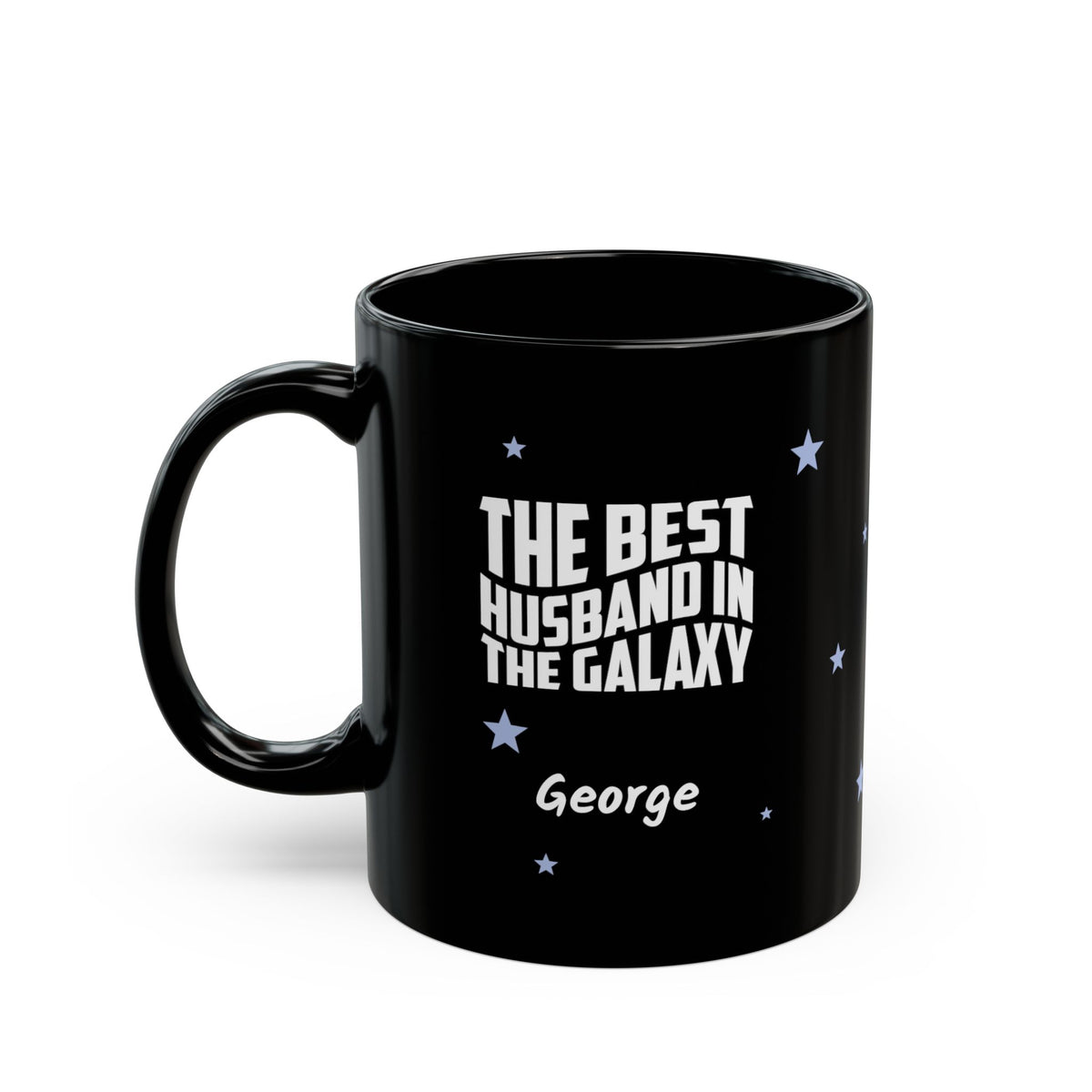 Black 11oz mug with small light blue stars and white text 'Best Husband in the Galaxy' with a personalize name below. Left handle view. Mug is placed on a white background