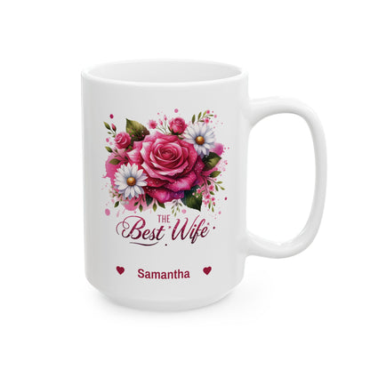 A white ceramic 15oz mug featuring a colorful floral design with pink roses, white daisies, and green leaves. Below the flowers, the text reads 'The Best Wife' in a cursive font, with 'Samantha' and small red hearts printed underneath. Right handle view.