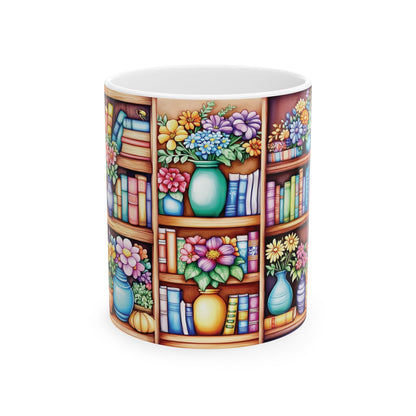 A white ceramic 11oz mug featuring a colorful wrap-around print of bookshelves filled with books and floral arrangements in vases, shown on a plain white background.