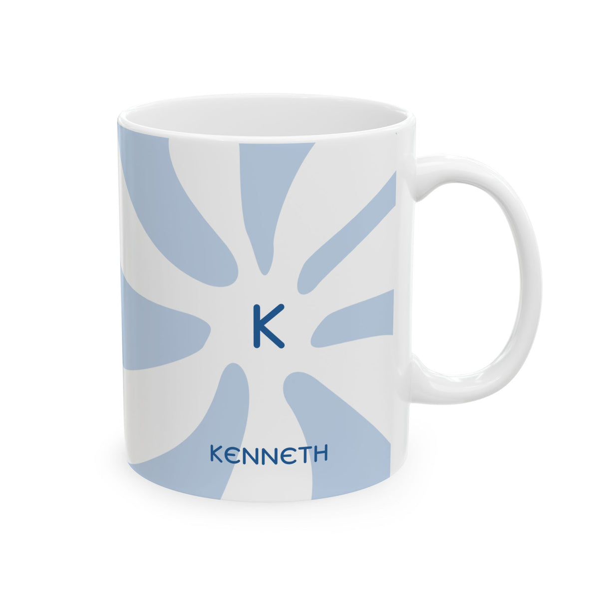 A white ceramic 11oz mug with a light blue sunburst pattern, featuring a dark blue monogram letter 'K' in the center and the name 'KENNETH' printed below, set against a plain white background. Right handle view.