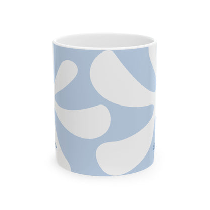 Side view of a white ceramic 11oz mug featuring an abstract light blue and white wavy pattern, shown on a clean white background. No handle visible.