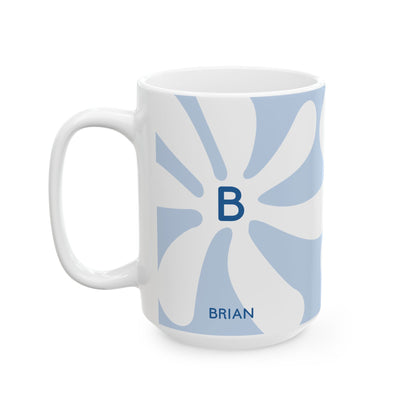 A white ceramic 15oz mug with a light blue retro sunburst pattern, featuring a dark blue monogram letter 'B' in the center and the name 'BRIAN' printed near the bottom. Left handle view.