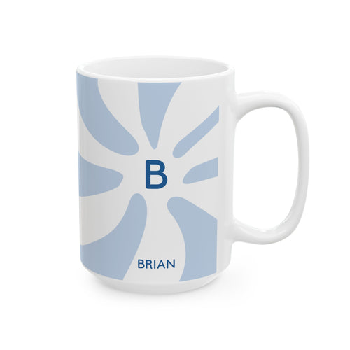 A white ceramic 15oz mug with a light blue sunburst pattern, a dark blue monogram letter 'B' in the center, and the name 'BRIAN' printed in dark blue near the bottom. Right handle view.