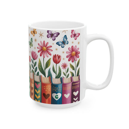 A white ceramic 15oz mug decorated with a colorful illustration of flowers, butterflies, and book spines on a white background. A personalized initial in a heart, on a book spine.