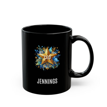 A black 11oz ceramic mug with a custom printed design featuring a gold star, blue floral accents, the text 'CEO' in the center, and personalized name 'JENNINGS' printed below in white. Right handle view. The mug is shown on a plain white background.