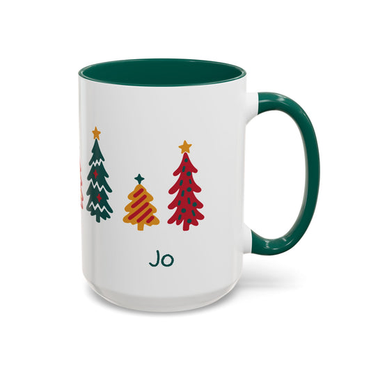 A white ceramic 15oz mug with a dark green handle and interior, decorated with seven colorful Christmas tree illustrations around the mug and the name 'Jo' printed below. Right handle view.