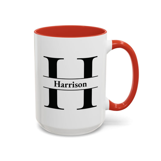 A white ceramic mug with a red interior and red handle, featuring a large black letter H and the name Harrison printed in black on the front.
