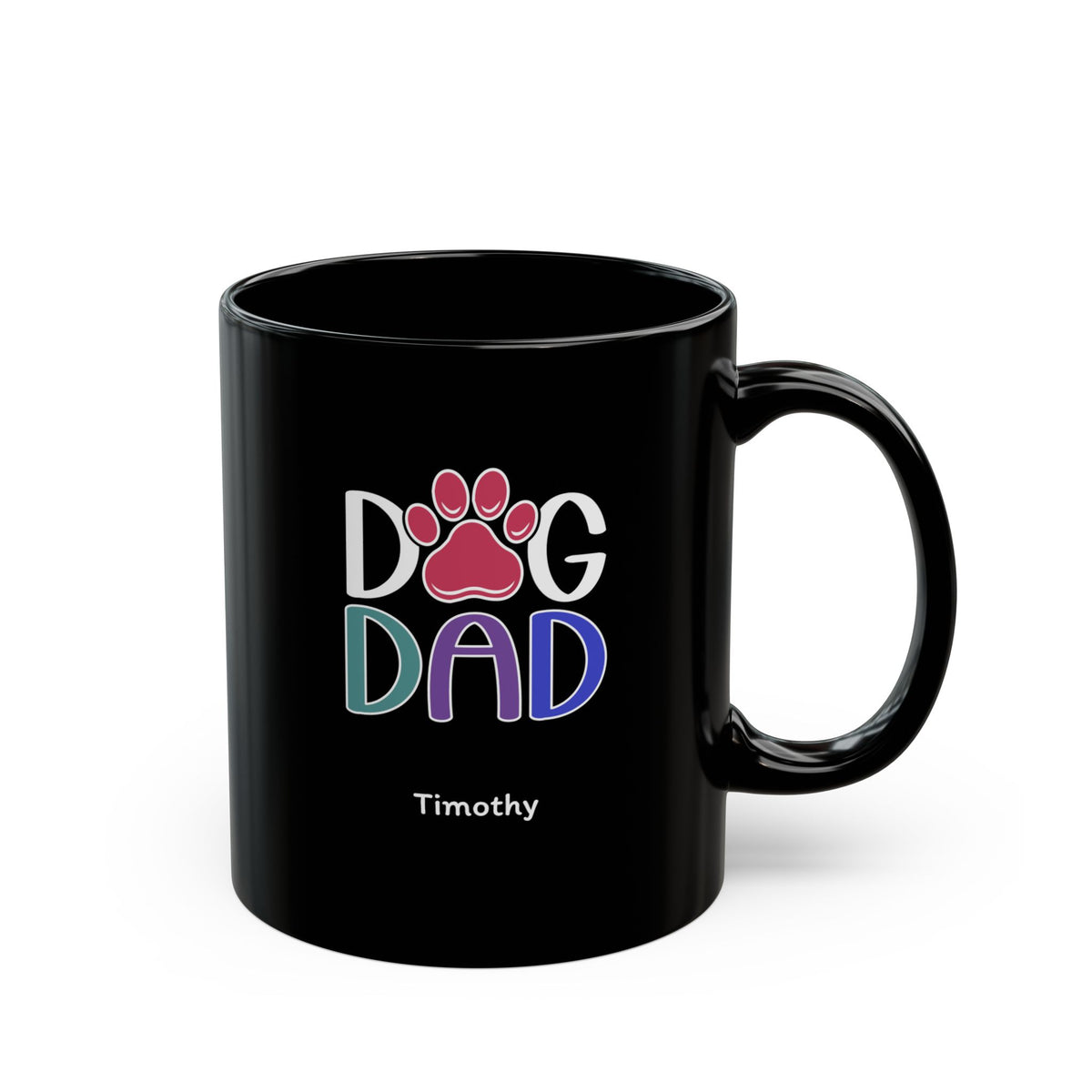 A glossy black 11oz ceramic mug featuring a colorful graphic that reads 'DOG DAD' with a pink paw print and the name 'Timothy' printed below in white, on a plain white background. Right handle view.