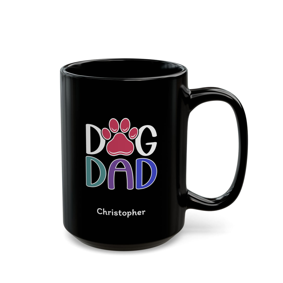 A glossy black 15oz ceramic mug featuring a colorful graphic that reads 'DOG DAD' with a pink paw print and the name 'Christopher' printed below in white, on a plain white background. Right handle view.