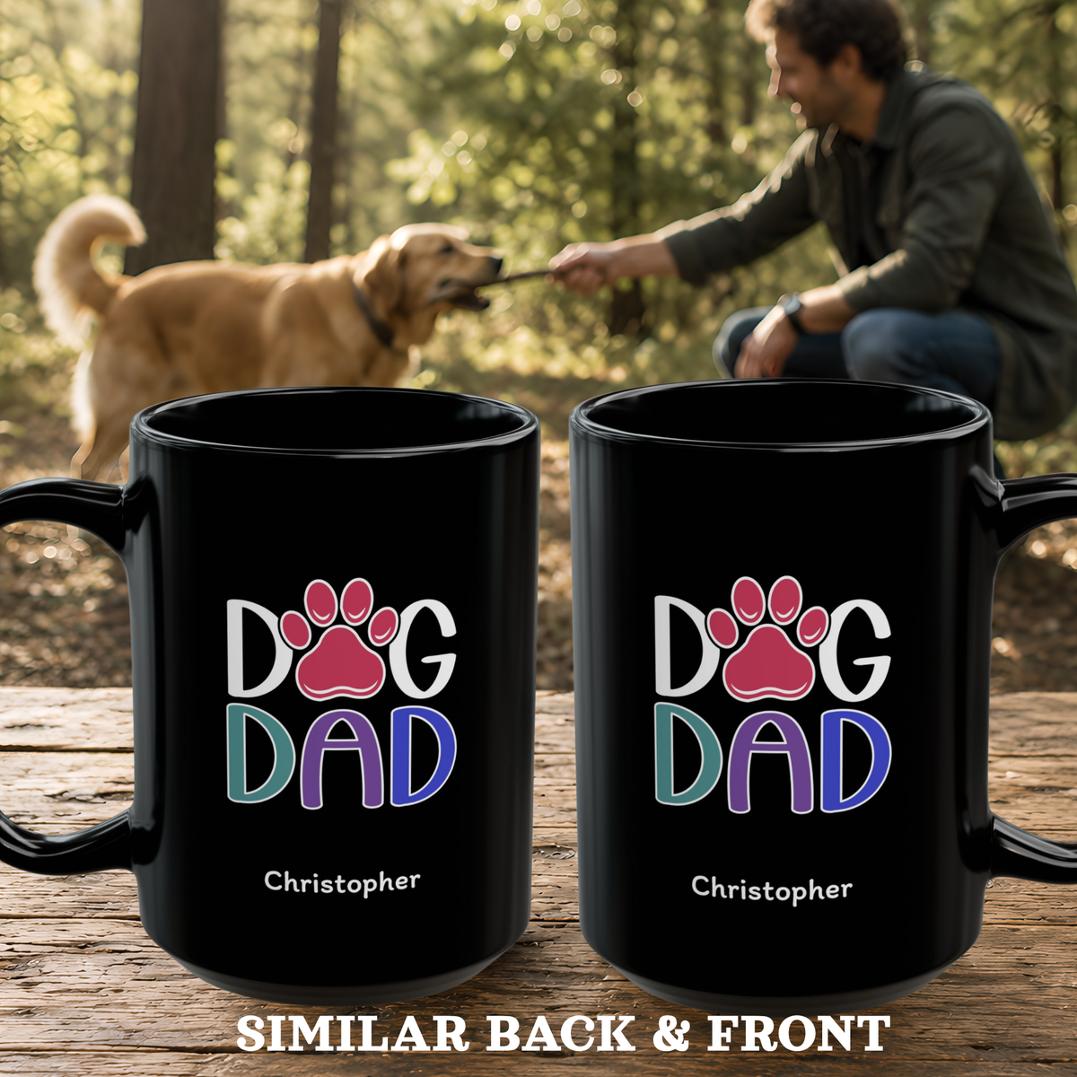 Two black mugs with a colorful 'DOG DAD' paw print design and the name 'Christopher' printed on them, displayed on a wooden surface with a blurred background of a man playing with a dog in a forest.