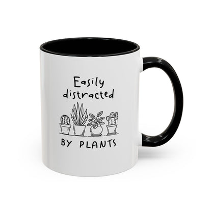 White accent mug with black handle, cacti and succulent graphic, 'easily distracted by plants' quote, 11oz.