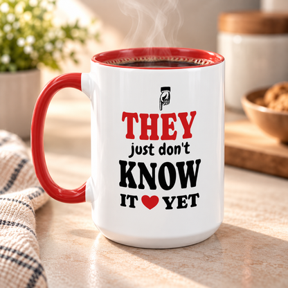 Red accent mug with 'they just don't know it yet' quote, filled with coffee, 15oz left side view.