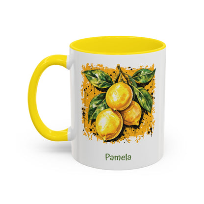 A white ceramic 11oz mug with a bright yellow handle and yellow interior, featuring a printed illustration of three yellow lemons with green leaves on darker yellow textured background. The name 'Michelle' is printed in green below the artwork. Left handle view.