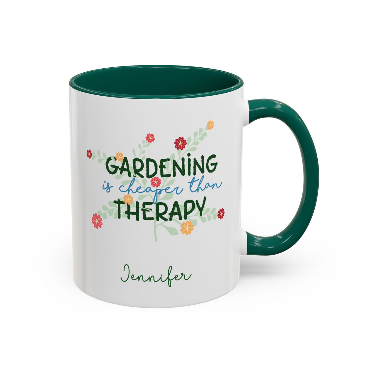A white ceramic 11oz mug with a dark green handle and interior, featuring the printed phrase 'GARDENING is cheaper than THERAPY' in green and blue script with small colorful flowers, and the name 'Jennifer' in green cursive below. Right handle view.