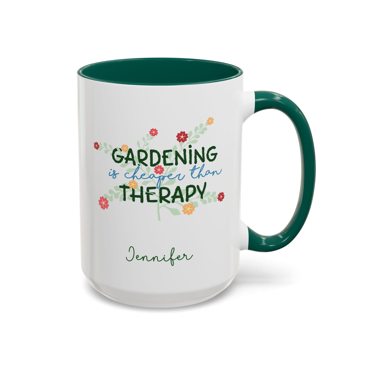A white ceramic 15oz mug with a dark green handle and interior, featuring the printed phrase 'GARDENING is cheaper than THERAPY' in green and blue script with small colorful flowers, and the name 'Jennifer' in green cursive below. Right handle view.