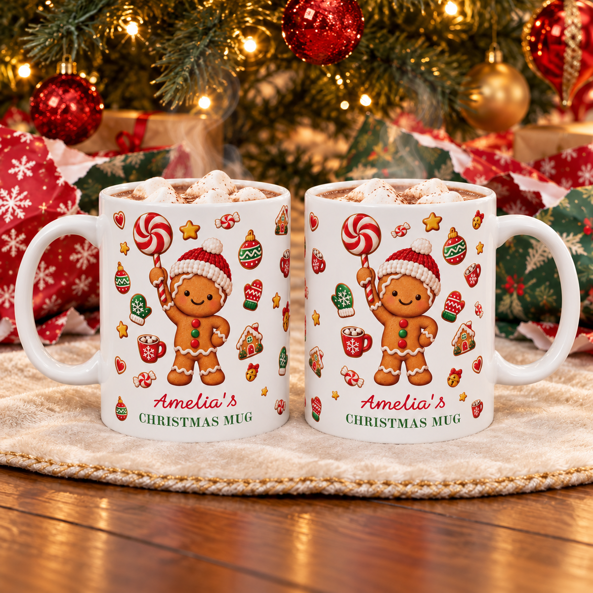 Two white ceramic 11oz gingerbread Christmas mugs with hot cocoa on a blanket in front of a decorated Christmas tree.