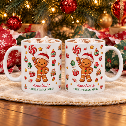 Two white ceramic 11oz gingerbread Christmas mugs with hot cocoa on a blanket in front of a decorated Christmas tree.