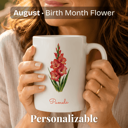 A woman holds a white ceramic mug with gladiolus birth flower and personalized name at bottom.