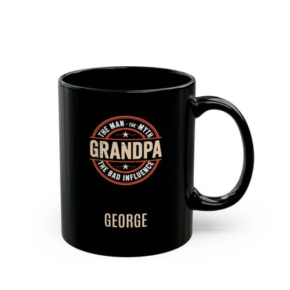 Black 11oz mug with 'Grandpa: The Man, The Myth, the Bad Influence' text and personalized name below. Right handle view. Mug is placed on a white background