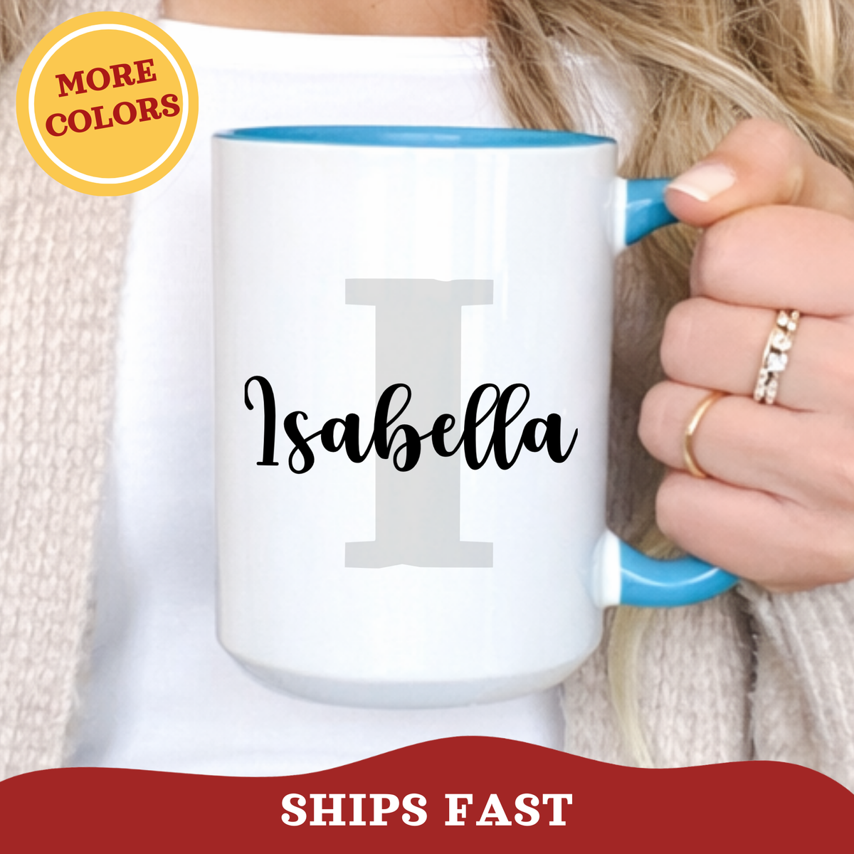 Person holding a personalized layered name and initial ceramic light blue mug with a colorful accent handle, with grey block initial 'I' and name Isabella printed over in a joyful script font.