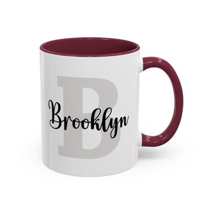 Personalized layered name and initial ceramic mug 11oz with a maroon accent inside and handle, studio product photo. Right handle view