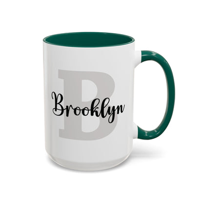 Personalized layered name and initial ceramic mug 15oz with a colorful green accent inside and handle, studio product photo. Right handle view