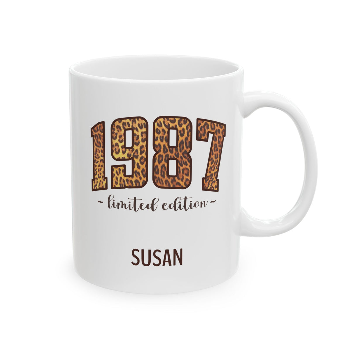 A white ceramic 11oz mug featuring a leopard print '1987' design with the text 'limited edition' and the name 'SUSAN' printed below, shown on a clean white background. Right handle view.