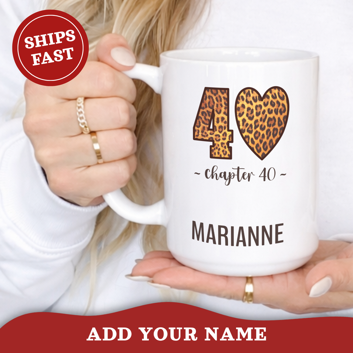 A white ceramic 15oz mug with a leopard-print '40' and heart design, held by a person wearing gold rings. The mug has 'chapter 40' and the name 'MARIANNE' printed on it.