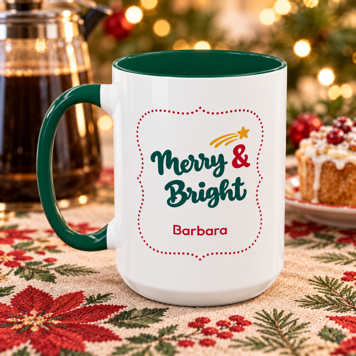 A white ceramic 15oz mug with a dark green handle and interior, printed with 'Merry & Bright' and the name 'Barbara' on a festive holiday table setting.