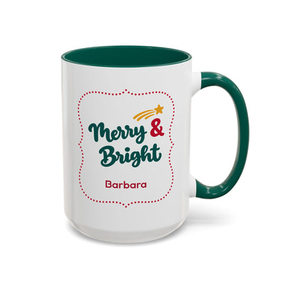 A white ceramic 15oz mug with a dark green handle and interior, featuring a festive graphic in thick script lettering that reads 'Merry & Bright' with a red dotted border, a small yellow shooting star, and the name 'Barbara' printed below. Right handle view.