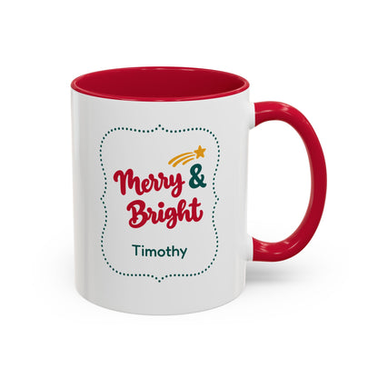 A white ceramic 11oz mug with a red interior and red handle, featuring a 'Merry & Bright' holiday graphic in bold red script lettering, and the personalized name 'Timothy' printed on the front, set against a plain white background. Right handle view.