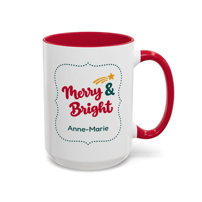 A white ceramic 15oz mug with a red interior and red handle, featuring a 'Merry & Bright' holiday graphic in bold red script lettering, and the personalized name 'Anne-Marie' printed on the front, set against a plain white background. Right handle view.