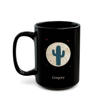 A 15oz glossy black ceramic mug, featuring a printed graphic of a teal cactus inside a beige circle with small red stars, and the name 'Gregory' printed below, left handle view.