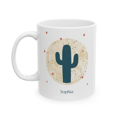 A white 11oz ceramic mug featuring a desert-themed graphic with a dark teal saguaro cactus, a textured beige circle resembling a moon, small red star accents, and the name Jocelyn printed below in dark teal, left handle view.