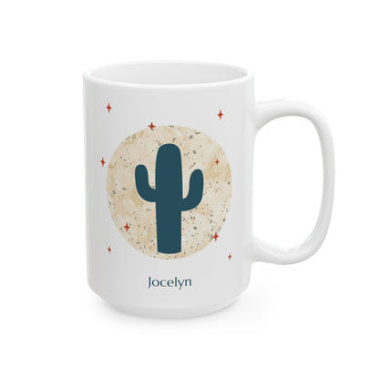A white 15oz ceramic mug with a desert-themed graphic featuring a dark teal saguaro cactus inside a textured beige circle, surrounded by small red stars. The name 'Jocelyn' is printed in dark teal below the design, right handle view.