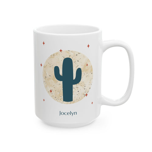A white 15oz ceramic mug with a desert-themed graphic featuring a dark teal saguaro cactus inside a textured beige circle, surrounded by small red stars. The name 'Jocelyn' is printed in dark teal below the design, right handle view.