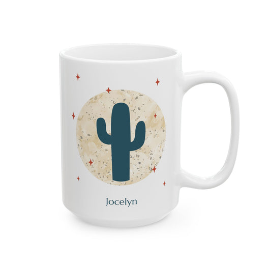A white 15oz ceramic mug with a desert-themed graphic featuring a dark teal saguaro cactus inside a textured beige circle, surrounded by small red stars. The name 'Jocelyn' is printed in dark teal below the design, right handle view.