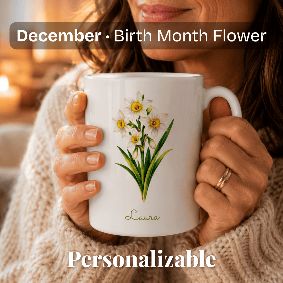A woman holds a white ceramic mug with narcissus birth flower with personalized name.