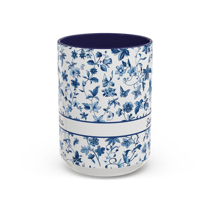A ceramic 15oz cup with a blue floral chinoiserie pattern on a white exterior and a solid dark blue interior, shown against a plain white background. Handle not visible.