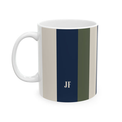 A white ceramic 11oz mug with vertical stripes in beige, navy blue, and olive green, featuring a white monogram 'JF' printed on the navy stripe. Left handle view.