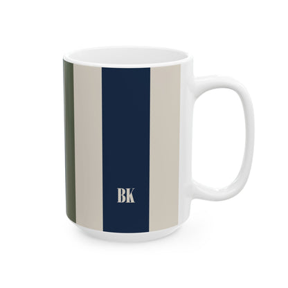 A white ceramic 15oz mug with wide vertical stripes in olive green, beige, and navy blue, featuring a beige monogram 'BK' on the navy stripe. Right handle view.