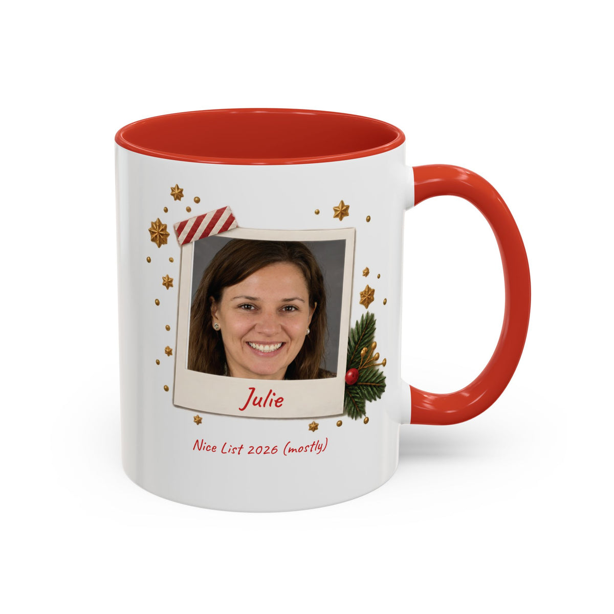 A white ceramic 11oz mug with a red interior and red handle, featuring a custom holiday polaroid photo frame design on the front with the name 'Julie' and the text 'Nice List 2026 (mostly)'. Right handle view.