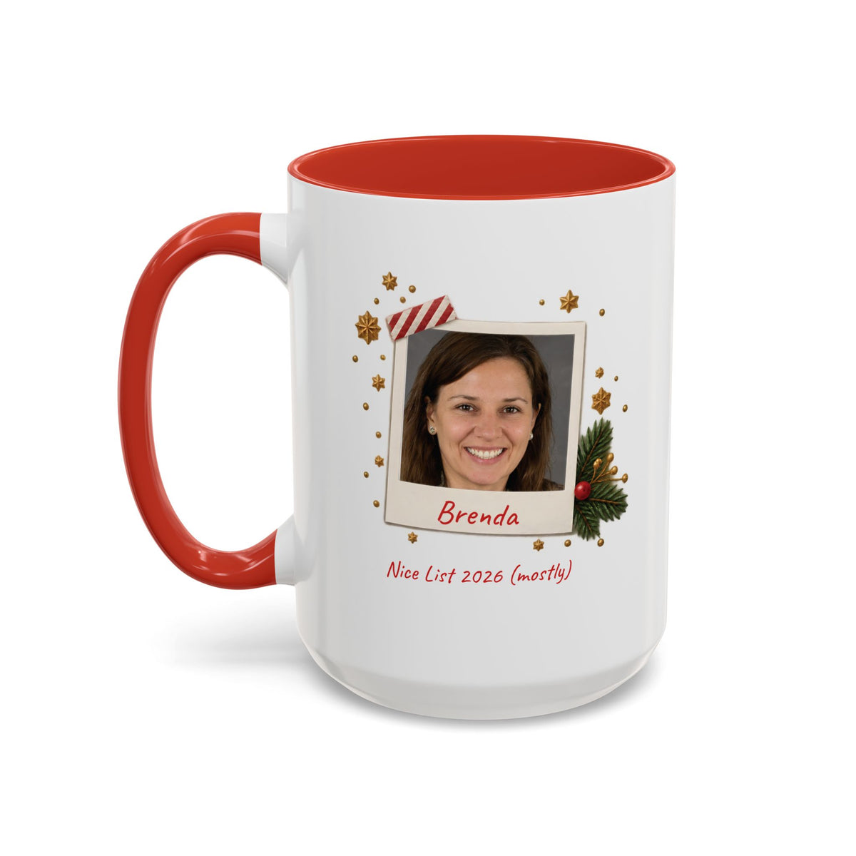 A white ceramic 15oz mug with a red interior and red handle, featuring a custom printed holiday polaroid photo frame design with the name 'Brenda' and the text 'Nice List 2026 (mostly)'. Left handle view.