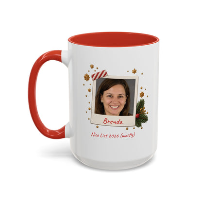 A white ceramic 15oz mug with a red interior and red handle, featuring a custom printed holiday polaroid photo frame design with the name 'Brenda' and the text 'Nice List 2026 (mostly)'. Left handle view.