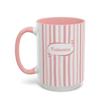 A ceramic 15oz mug with vertical pink and white stripes, a solid pink handle and interior, and a white base. The front features a white label with pink border and the name 'Francesca' in pink script. Left handle view.