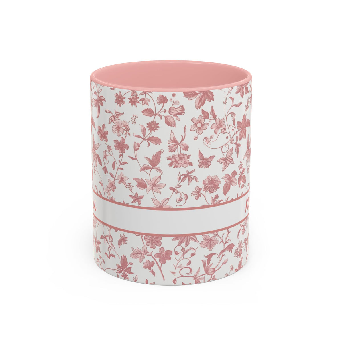 A white ceramic 11oz mug with a pink floral chinoiserie pattern, a pink handle, and a pink interior. A white band around the middle. Handle not visible.
