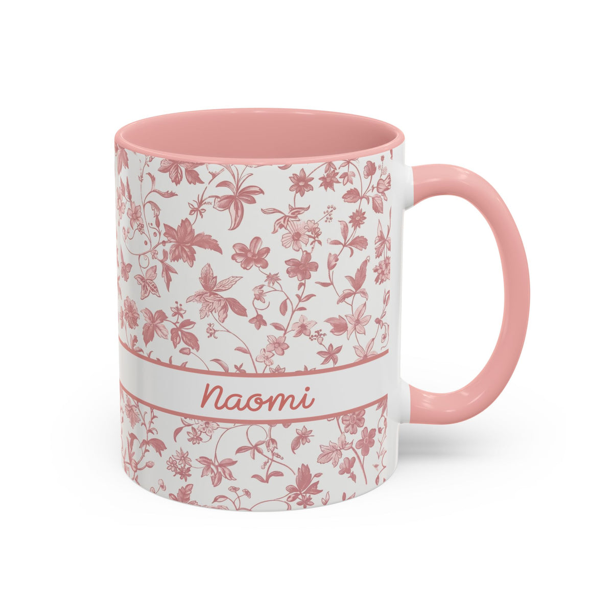 A white ceramic 11oz mug with a pink floral chinoiserie pattern, a pink handle, and a pink interior. A white band around the middle features the name 'Joanna' in pink script. Right handle view.